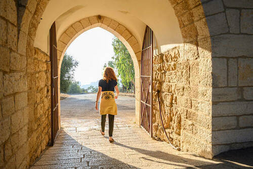 Elsa Barron, a Glynn student, walking through a gate In Tantur, Jerusalem